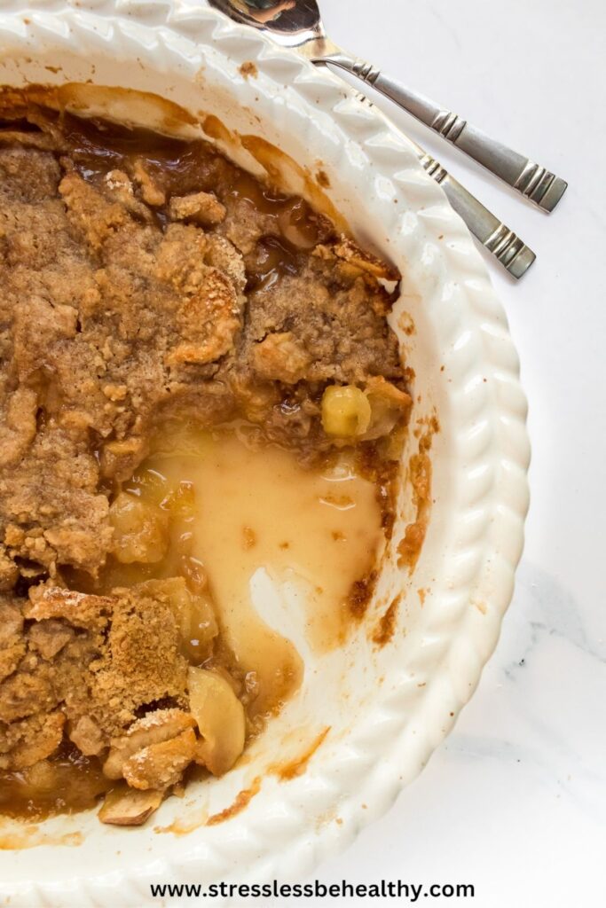 Dairy Free apple crisp in a baking dish with a serving missing.