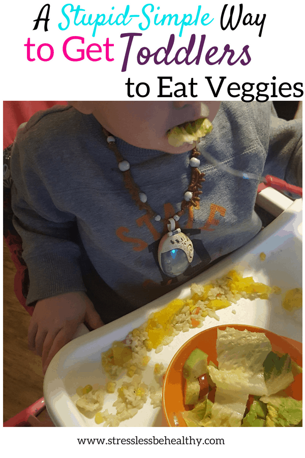 get toddlers to eat veggies, toddler in highchair eating a salad, rice, and mango