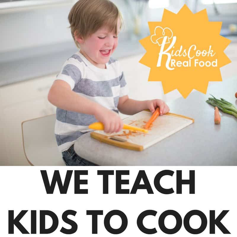 little boy cutting up food, learning to cook