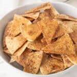 Homemade Cinnamon sugar tortilla chips in a white bowl.