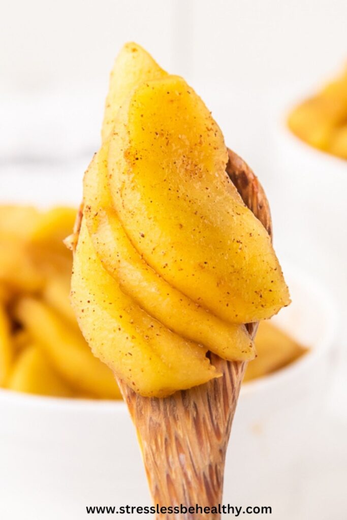 Gently cooked apples on a spoon.