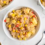 Quinoa with veggies in a white bowl.