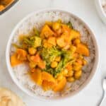 1 white bowl with Sweet Potato Chickpea Curry in it, sitting on top of a bed of white rice.
