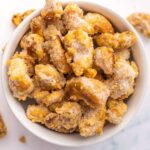 Sugar Coated Candied cashews in white bowl.