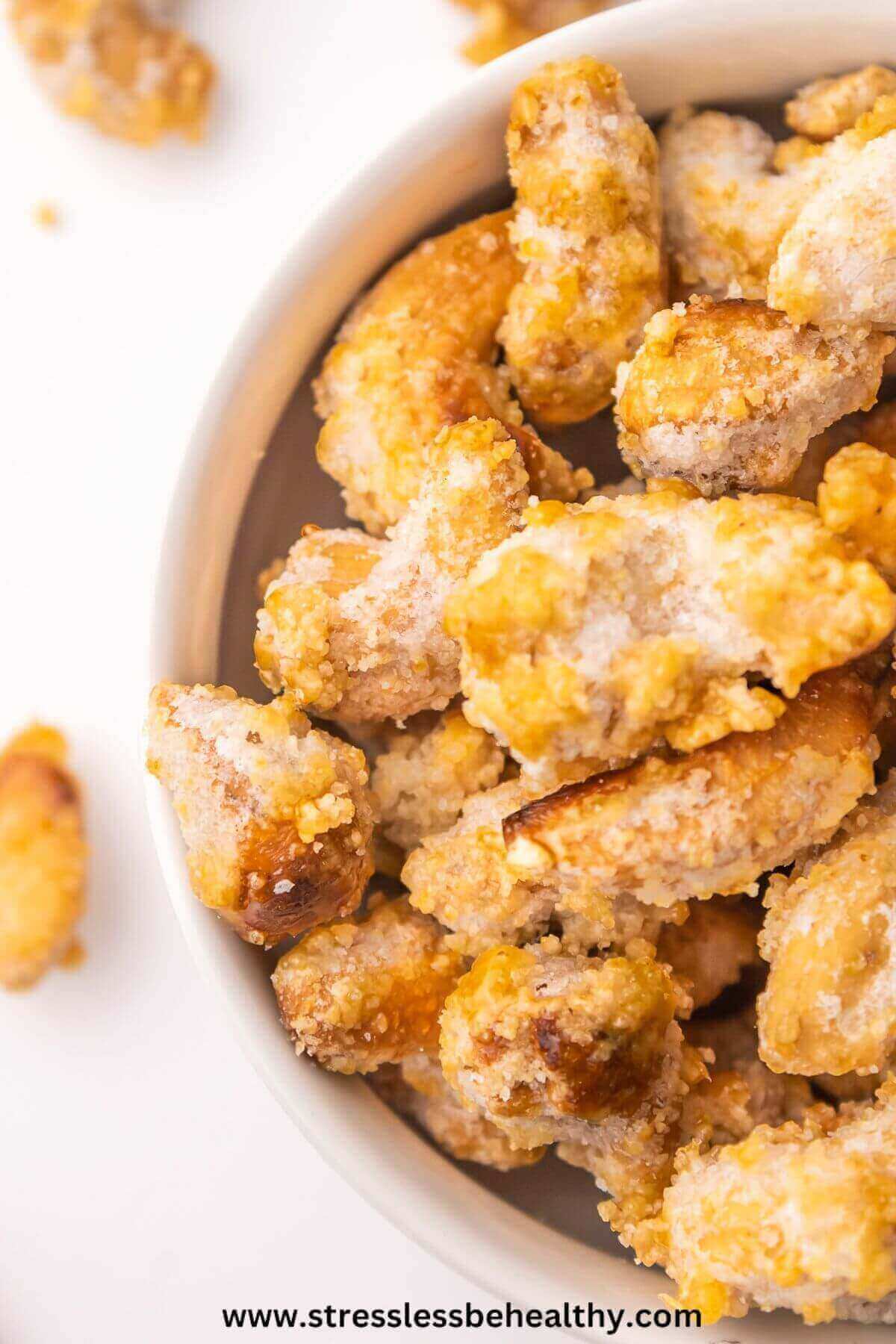 Close up of candied cashews in a white bowl.