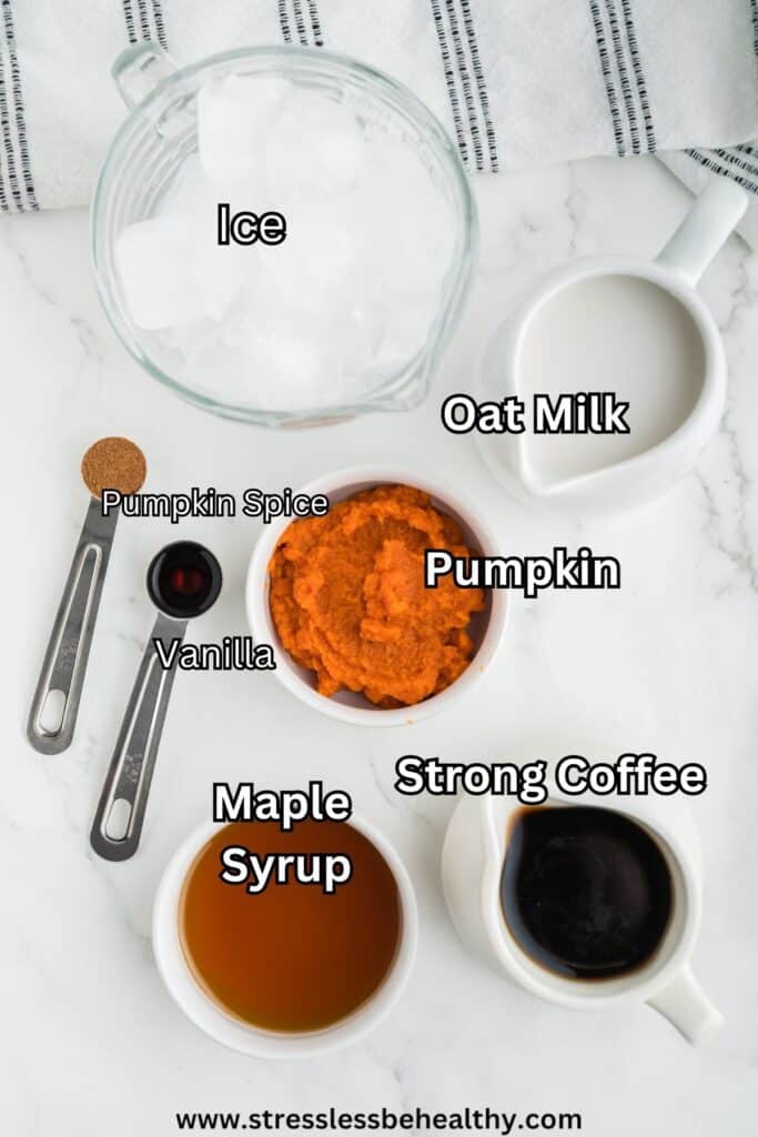 Iced Pumpkin Spice Latte ingredients laid out on a white marble countertop.