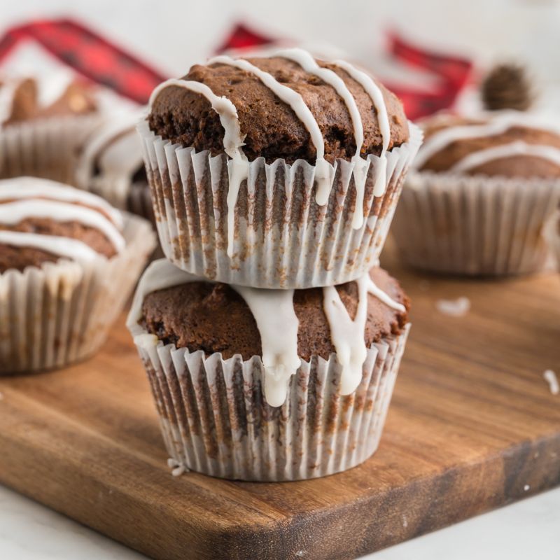 2 Vegan Gingerbread Muffins iced and stacked on top of each other.