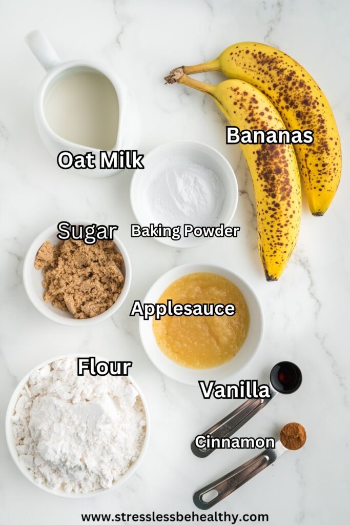 Vegan banana pancakes ingredients laid out on a white marble countertop.