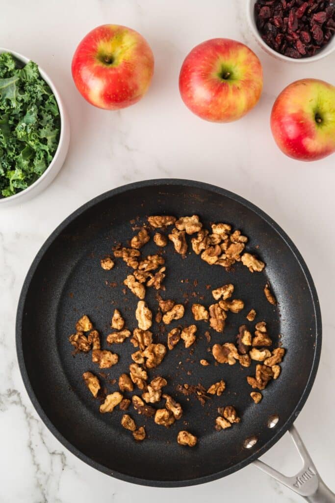 Toasting cinnamon walnuts for Kale Apple Salad.