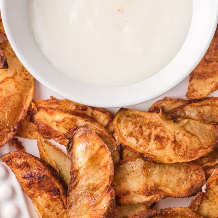 Air Fryer Apples on dish with simple vanilla icing