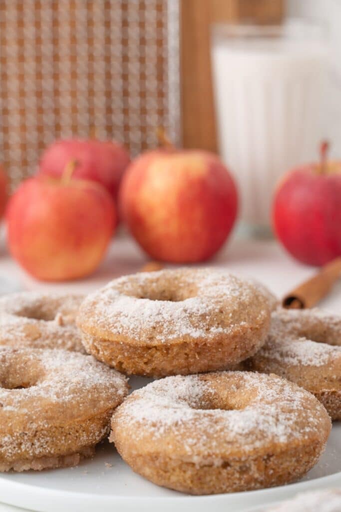 Vegan Apple Cider Donuts piled on a white plate.