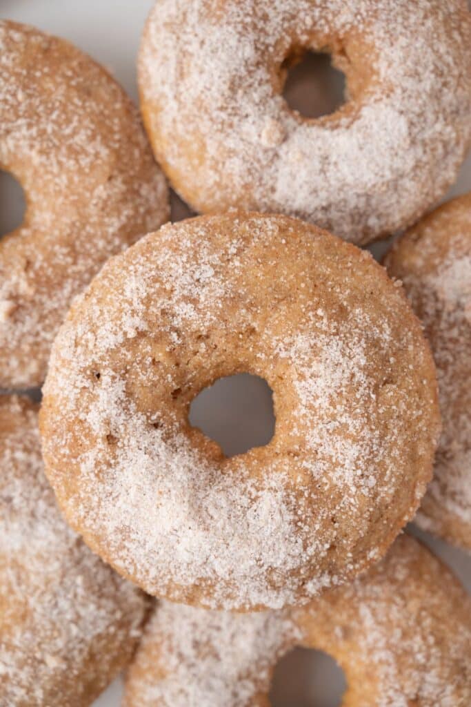 Vegan Apple Cider Donuts close up of them piled.