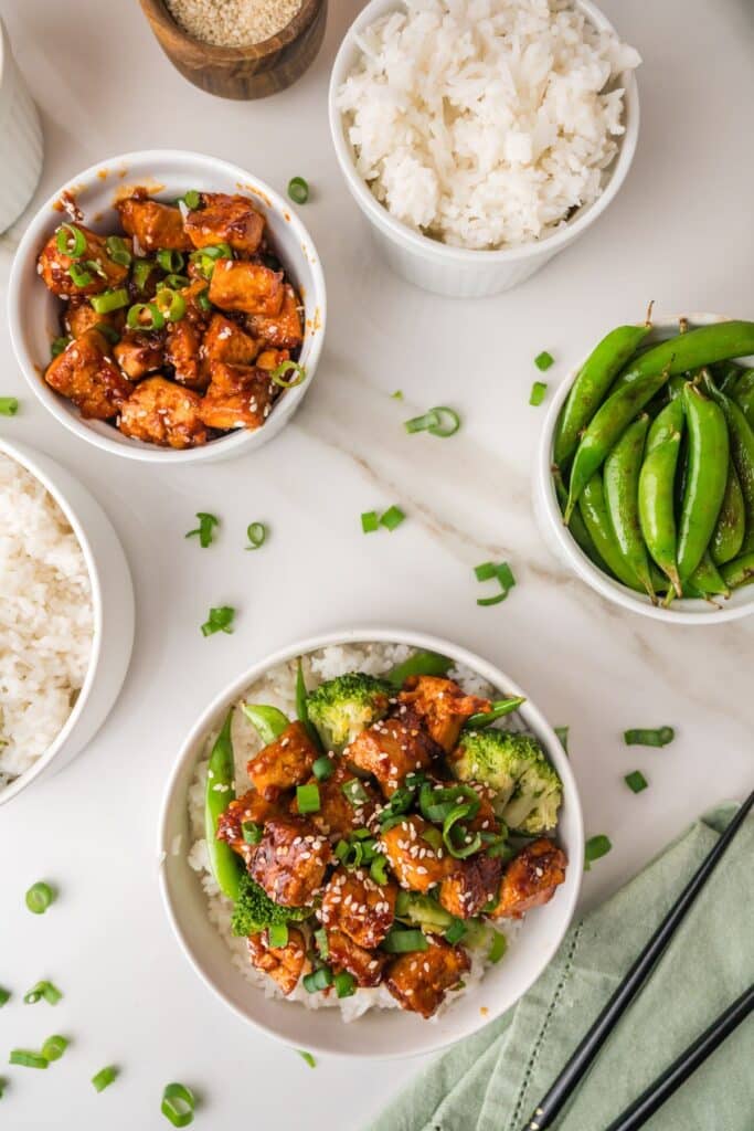 Overhead shot of Gochujang tofu with sweet peas and white rice.