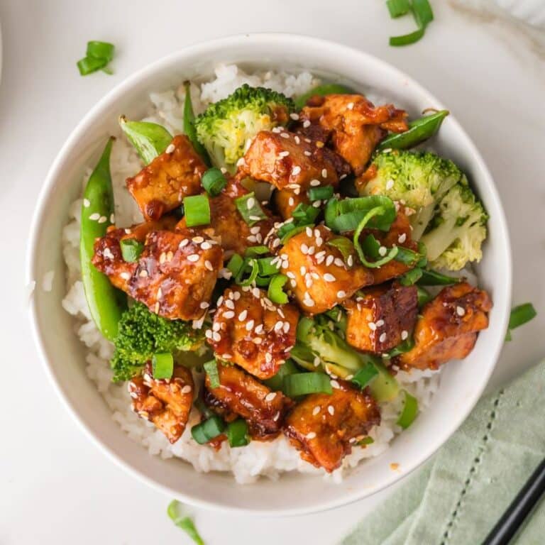 Gochujang tofu in bowl with broccoli, sweet peas, and white rice.